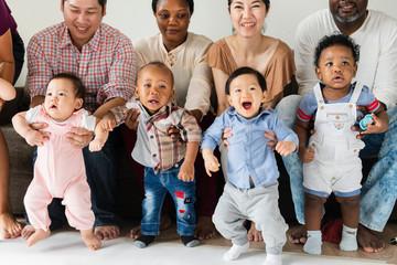 parents holding toddlers
